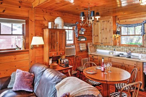 a living room with a couch and a table in a kitchen at Newport Cabin with Lakefront Private Porch and Grill! in Newport