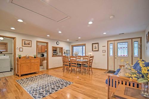 a kitchen and dining room with a table and chairs at Riverfront Elkins Home with Fireplace and Deck! in Elkins