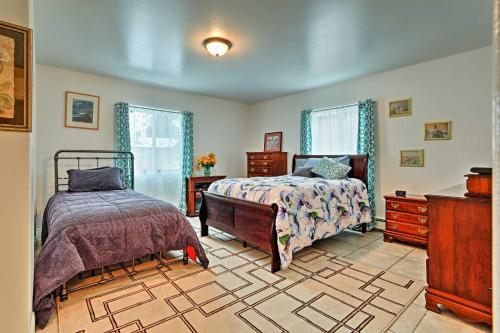 a bedroom with two beds and a dresser at Expansive Getaway about 2 Miles to Mendenhall Glacier! in Mendenhaven