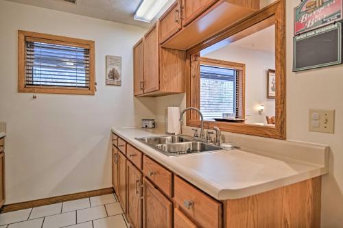 a kitchen with a sink and a mirror at Riverfront Elkins Home with Fireplace and Deck! in Elkins