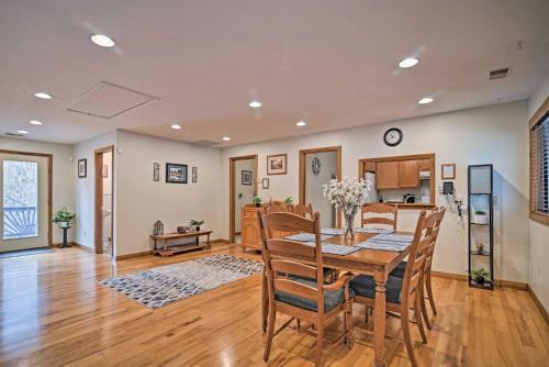 a dining room and kitchen with a table and chairs at Riverfront Elkins Home with Fireplace and Deck! in Elkins