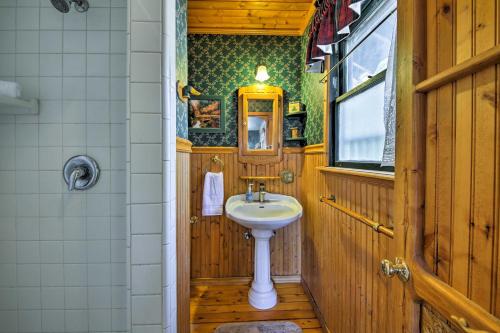 a bathroom with a sink in a wooden room at Cabin with Deck and Views Steps from Big Bear Lake in Fawnskin