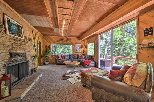 a living room with couches and a fireplace at Expansive Retreat with Deck, Game Room and Lake Views! in Lake Arrowhead