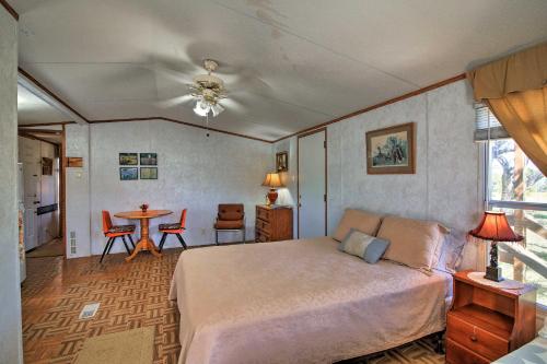 a bedroom with a bed and a table with chairs at Quiet Utopia Cabin with Deck and Mountain Views! in Utopia