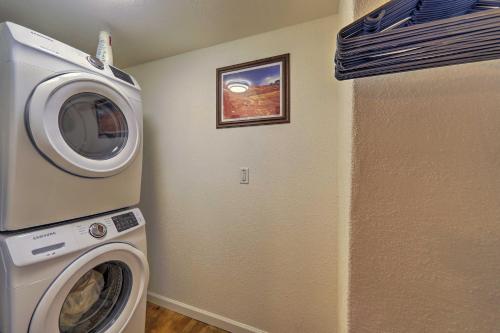 a laundry room with a washing machine and a picture at Winslow Apartment with Jacuzzi, Deck and Grill Access! in Winslow