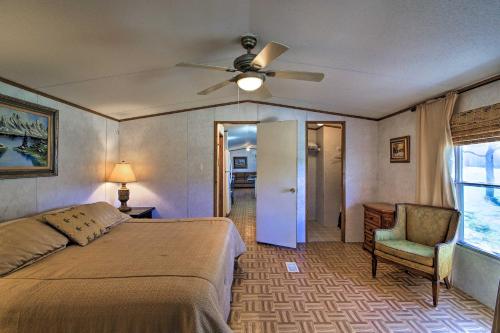 a bedroom with a bed and a ceiling fan at Quiet Utopia Cabin with Deck and Mountain Views! in Utopia