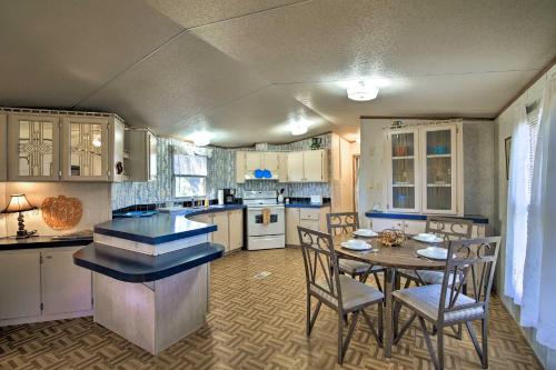 a kitchen with a table and chairs in a room at Quiet Utopia Cabin with Deck and Mountain Views! in Utopia