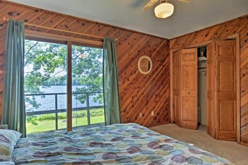 una camera con un letto e una grande finestra di Spider Lake Cabin Boathouse, Canoe, Deck and Sauna! a Iron River