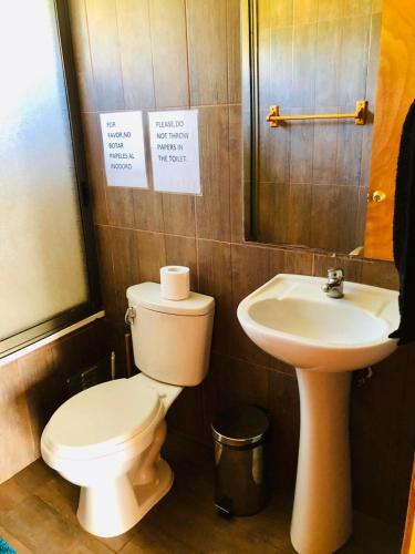 a bathroom with a toilet and a sink at Rangi Moana in Hanga Roa