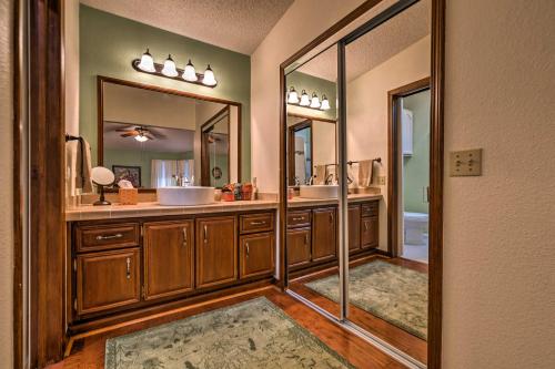 a bathroom with two sinks and two mirrors at Lovely Lady Lake Home with Resort Amenities and Lanai! in Lady Lake