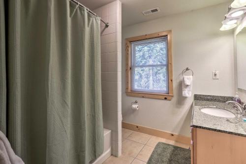 a bathroom with a shower and a sink and a window at Carnelian Bay Home with Hot Tub Near Tahoe Skiing in Carnelian Bay