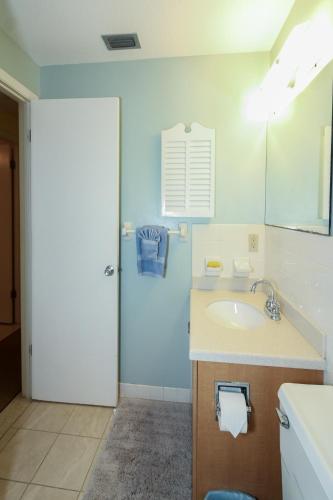 a bathroom with a sink and a mirror at Bamboo Apartments in Holmes Beach