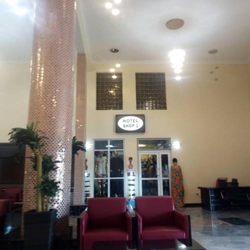 a lobby with chairs and a clock in a store at Conference Hotel , Abeokuta in Abeokuta