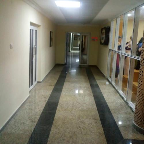 a hallway in a building with black stripes on the floor at Conference Hotel , Abeokuta in Abeokuta