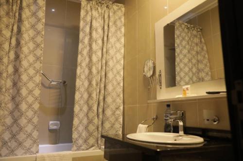 a bathroom with a sink and a shower at Conference Hotel , Abeokuta in Abeokuta