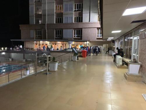 a hallway of a building with people walking around at Conference Hotel , Abeokuta in Abeokuta
