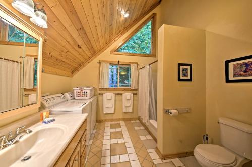 a bathroom with a sink and a toilet at Lakeside Sagle Home with Dock-by Schweitzer Mtn! in Sagle