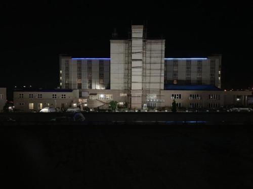 a large building with blue lights on it at night at Conference Hotel , Abeokuta in Abeokuta
