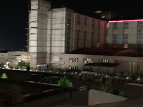 a large building at night with a building at Conference Hotel , Abeokuta in Abeokuta