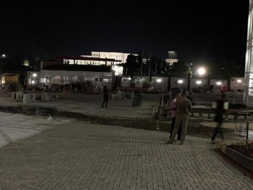a group of people standing on a street at night at Conference Hotel , Abeokuta in Abeokuta