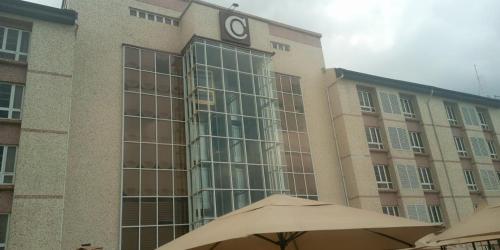 a large building with a clock on the side of it at Conference Hotel , Abeokuta in Abeokuta