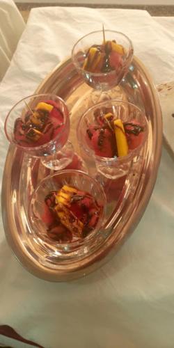 a glass tray with four bowls of fruit on a table at Conference Hotel , Abeokuta in Abeokuta