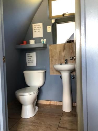 a bathroom with a toilet and a sink at Rangi Moana in Hanga Roa