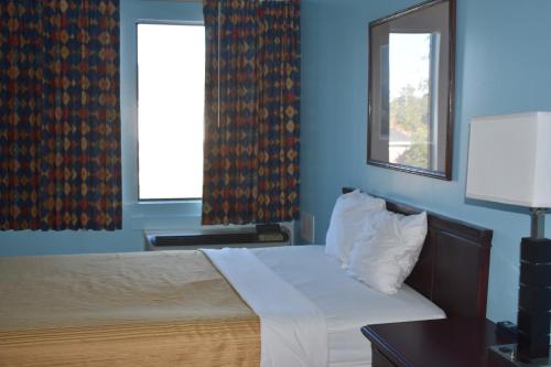 מיטה או מיטות בחדר ב-Guest Cottages & Suites
