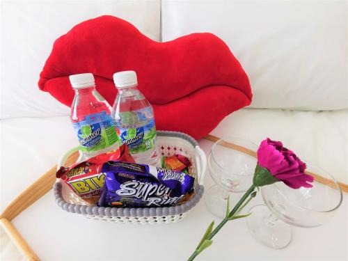 a basket with drinks and snacks on a table at Infistay Homestay - Sunway Geo Avenue, Sunway Pyramid, Sunway Lagoon, Sunway University, Sunway Medical Centre in Subang Jaya