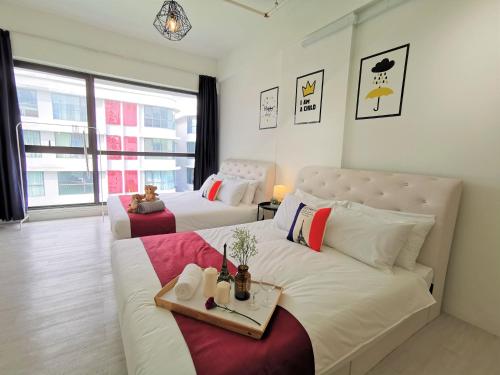 a bedroom with two beds and a large window at Infistay Homestay - Sunway Geo Avenue, Sunway Pyramid, Sunway Lagoon, Sunway University, Sunway Medical Centre in Subang Jaya