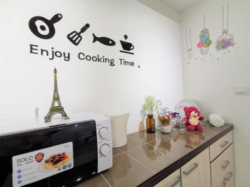 a microwave in a kitchen with the words enjoy cooking time at Infistay Homestay - Sunway Geo Avenue, Sunway Pyramid, Sunway Lagoon, Sunway University, Sunway Medical Centre in Subang Jaya