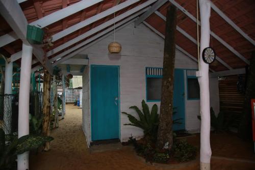 a building with a blue door and a clock at Brother's Beach Home in Galle