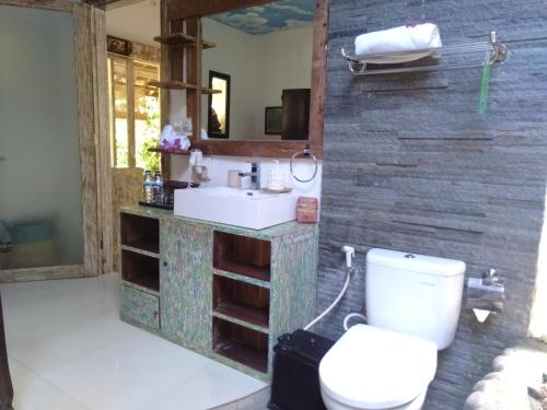 a bathroom with a toilet and a sink at KTS Balinese Villas in Canggu