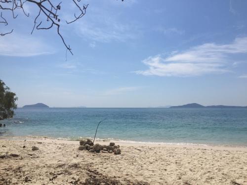 a pile of rocks on a beach near the water at Homebar in Ko Chang