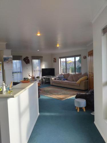 a living room with a couch and a table at My Place BnB in Tuatapere