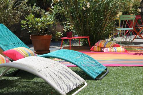 two surfboards are laying on the grass next to a bench at Oasi Hotel in Levanto