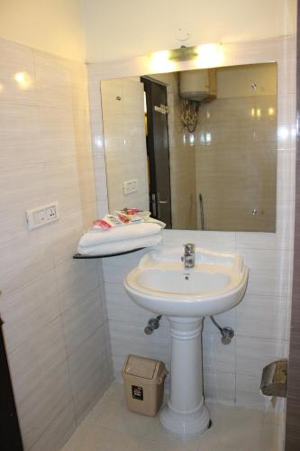 a bathroom with a sink and a mirror at Hotel Hong Kong Inn in Amritsar