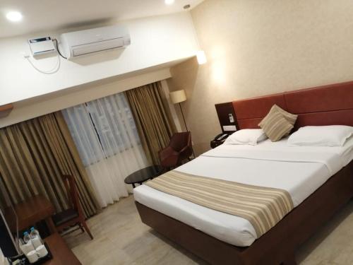 Säng eller sängar i ett rum på Hotel Aida
