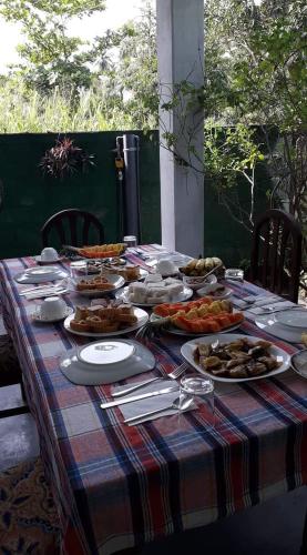 a table with a platter of food on it at Monara Backpacker Inn Unawatuna in Unawatuna