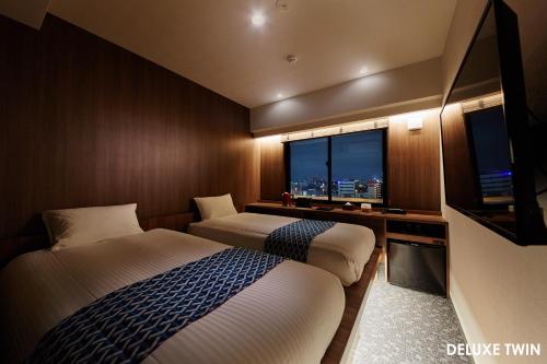 Un ou plusieurs lits dans un hébergement de l'établissement HOTEL AMANEK Asakusa Ekimae