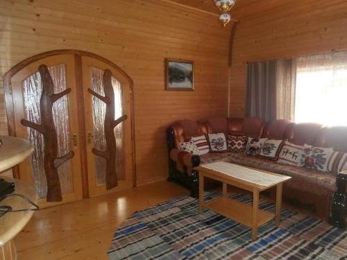 a living room with a couch and a table at Karpatskiy Domyk in Izki