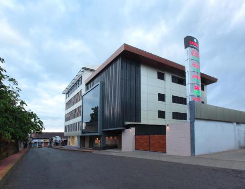 a building with a large window on the side of it at Hotel Samrat in Taliparamba