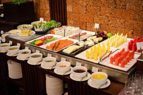 a buffet line with many different types of food at Jaya House River Park Hotel in Siem Reap