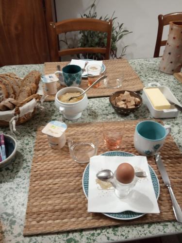a table with a plate of food on it at Le Clos du Buisson in Saint-Julien-de-la-Liègue