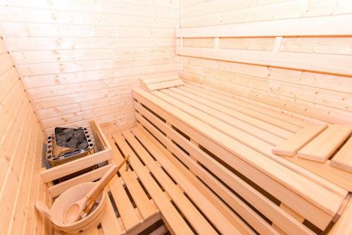 a wooden sauna with a toilet in it at Villapark Lipno Dreams in Lipno nad Vltavou