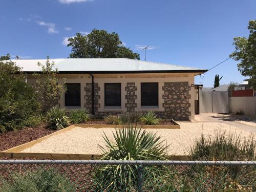 a house with a fence in front of it at Cute and Cosy II - Events, Workers, Getaways. in Murray Bridge