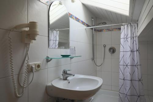 a bathroom with a sink and a shower at Haus Luna - Apartments in Schwangau