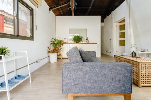 a living room with a couch and a table at Hearty Cottage in Hualien City