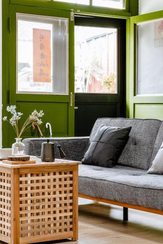 a living room with a couch and a table at Hearty Cottage in Hualien City