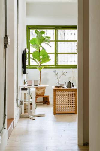a plant in a room with a window at Hearty Cottage in Hualien City